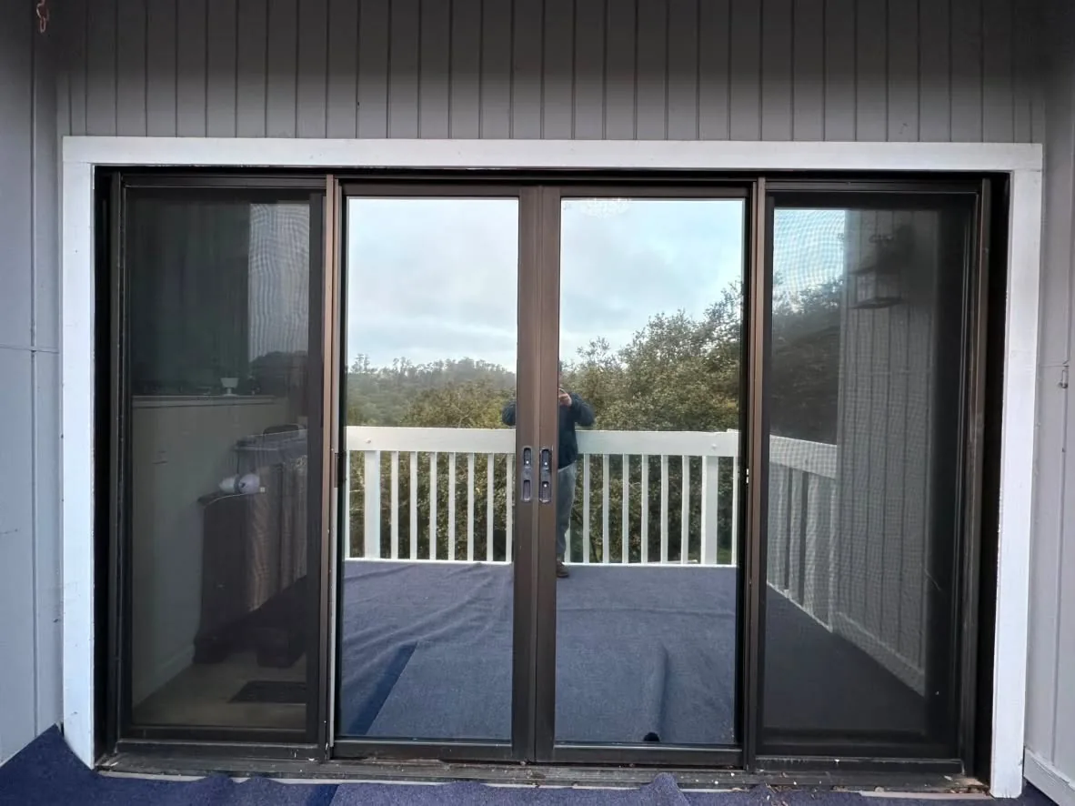 Double patio doors with residential window film looking out to a deck